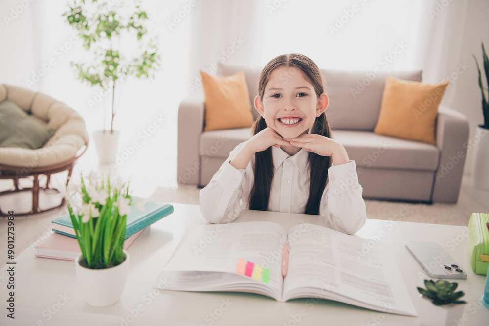 Photo portrait of cute small schoolgirl cute smile do homework home education concept school interior Photo portrait of cute small schoolgirl cute smile do homework home education concept school interior