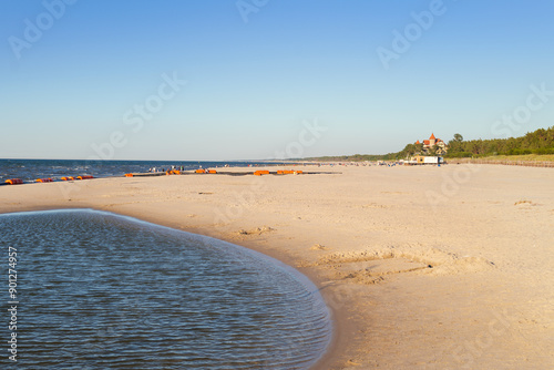 Obraz na płótnie View of the beach in Leba. Beautiful wide beach on a sunny day. Castle and people in the distance. Leba, Poland w salonie