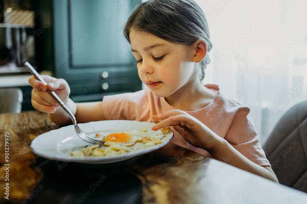 Girl eating scrambled eggs in breakfast at home Girl eating scrambled eggs in breakfast at home