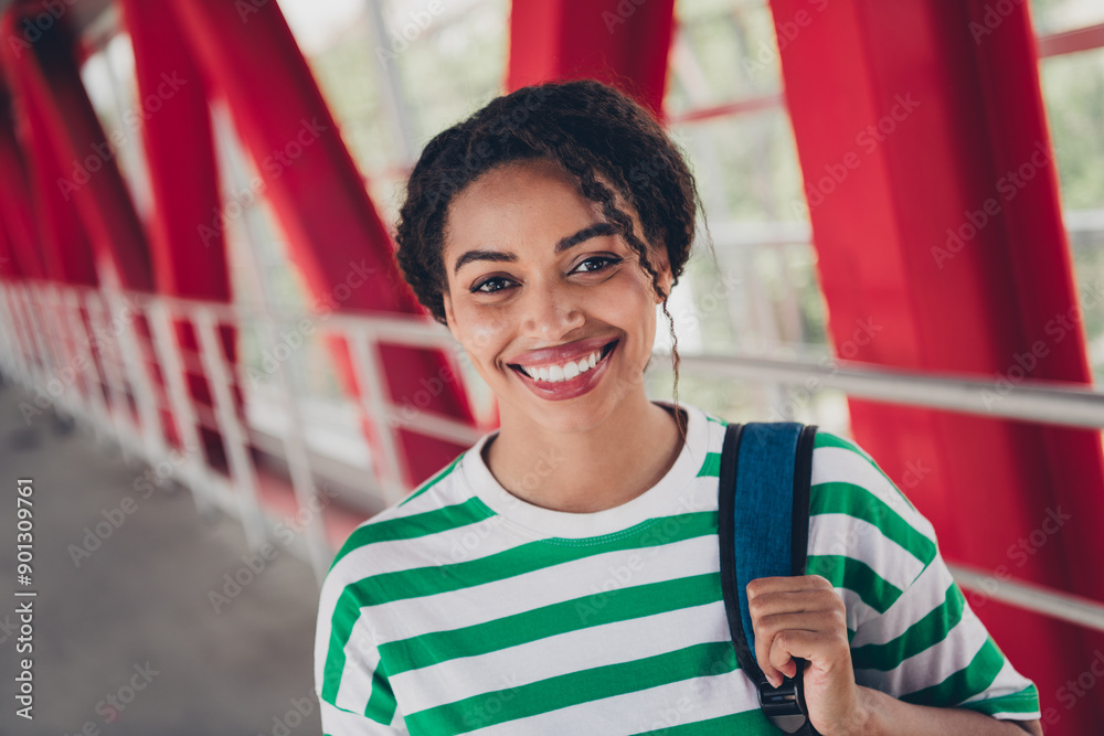 Naklejka premium Photo of pretty young woman toothy smile striped t-shirt backpack work study business center office