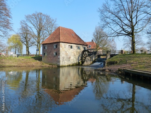 The old Mallum watermill near Eibergen in winter, with a beautiful reflection in the water of the mill pond. photo