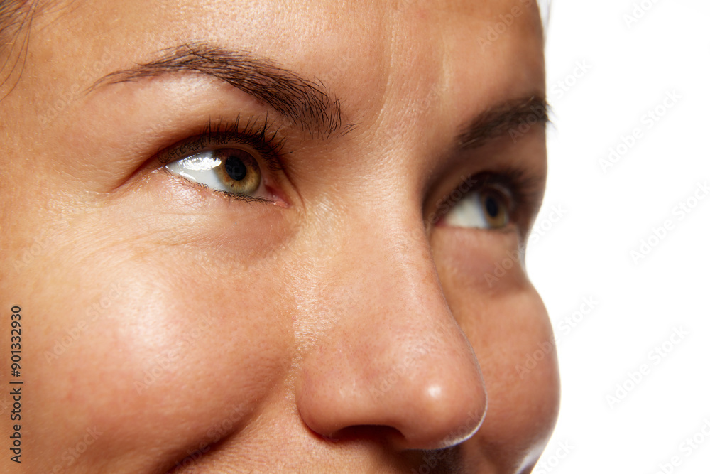 Fototapeta premium Detailed photo of woman's face, preorbital zone with well-kept, smooth skin against white studio background. Anti-aging skincare cosmetic products. Concept of facial care, lifting, spa procedures.