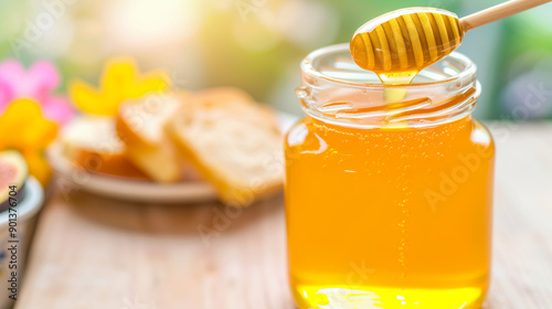 A jar of honey is poured into a spoon