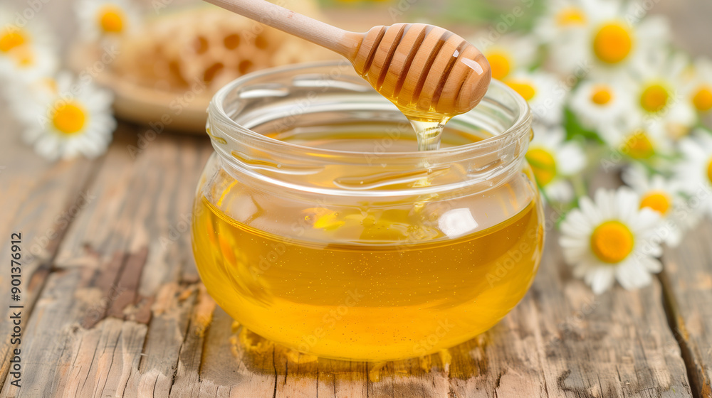 A jar of honey is sitting on a wooden table A jar of honey is sitting on a wooden table