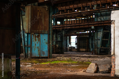 Old factory with objects abandoned inside and growing nature, power of life