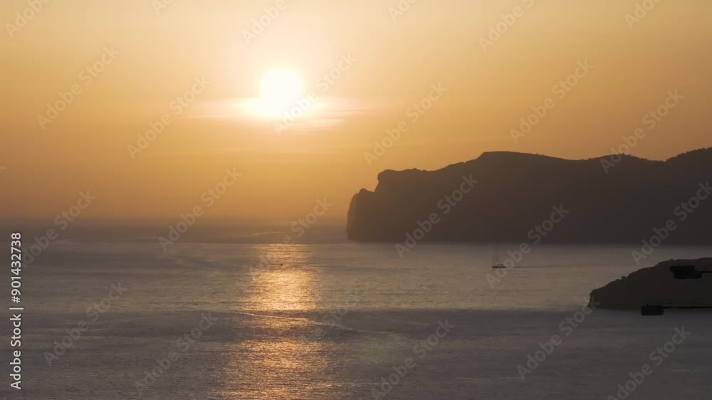 Calm yellow hue sunset scenery with mountain silhouette in sea, Mallorca Calm yellow hue sunset scenery with mountain silhouette in sea, Mallorca