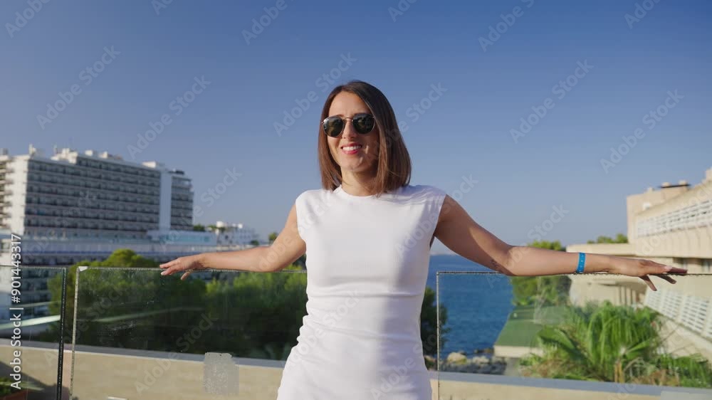 Pretty female lean on balcony glass safety barrier, summertime in Mallorca Pretty female lean on balcony glass safety barrier, summertime in Mallorca