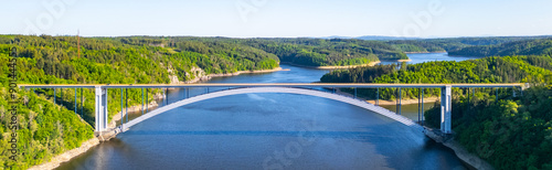 The Zdakov Bridge in the Czech Republic is a modern arch bridge over the Vltava River, offering a clear view of the surrounding countryside. © pyty