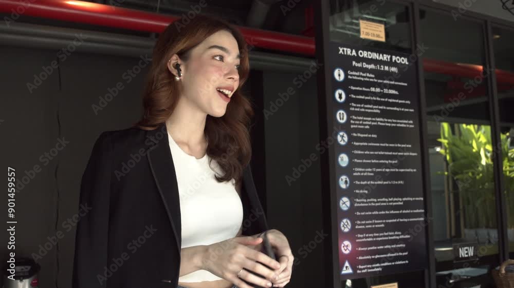 Business woman working outside picking up mobile with smart watch and talking with wireless earpods. Business woman working outside picking up mobile with smart watch and talking with wireless earpods.