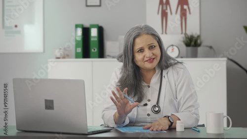 Happy Indian female senior doctor giving medicine to the patient