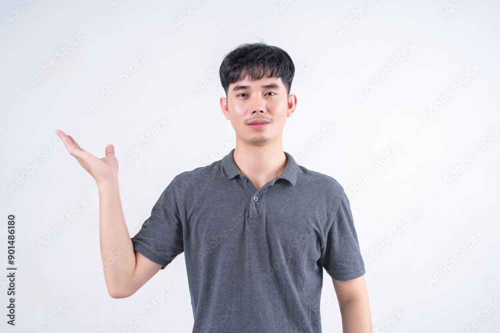 Portrait of handsome Asian man with open arms and empty spread hands. Marketing and advertising concept on white background. Portrait of handsome Asian man with open arms and empty spread hands. Marketing and advertising concept on white background.