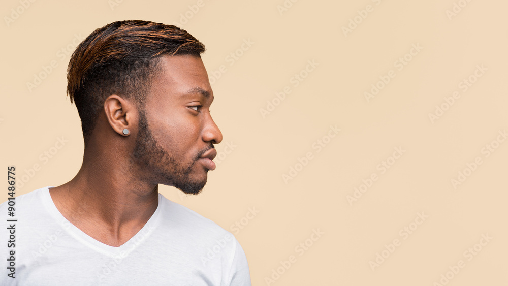 Fototapeta premium Profile Portrait Of African American Man Standing Over Yellow Studio Background. Panorama, Side View, Copy Space