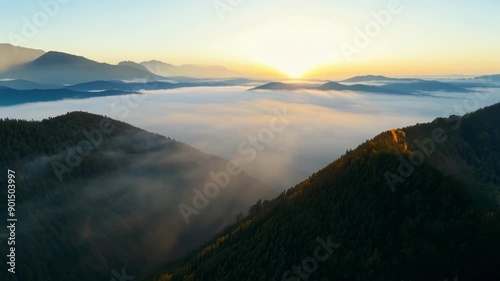 The morning mist clings to the valleys below as the camera captures the serene beauty of the sunkissed mountain ridges. photo