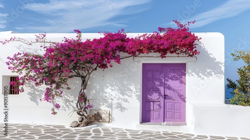 Fototapeta Naklejka Na Ścianę i Meble -  A white building stands tall with a purple door at its entrance Purple flowers flourish along the building's sides, accentuating the elegance of the structure Nearby