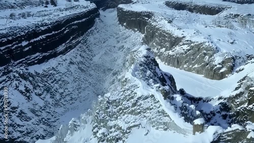 A birdseye view of the intricate patterns created by the twists and turns of a snowcovered canyon.