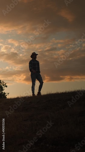 A man walking on a hilly sunset, evoking solitude, contemplation, freedom in scenic outdoor space