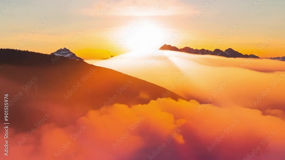 Bright orange and pink streaks are painted across the fluffy white clouds as the sun continues its ascent over the snowy peaks. Bright orange and pink streaks are painted across the fluffy white clouds as the sun continues its ascent over the snowy peaks.