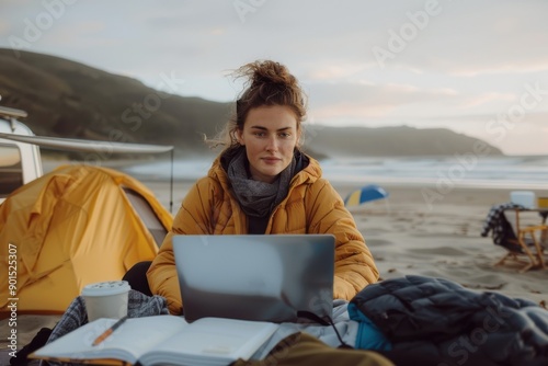 A woman sits at a beach using a laptop amidst a serene sunset, depicting the blend of work and relaxation, and the pursuit of a balanced life in a picturesque setting.
