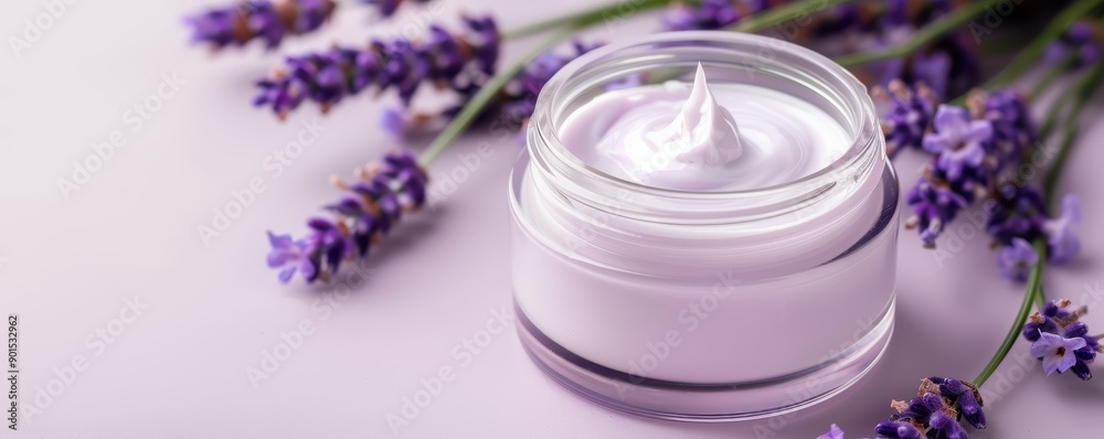 Luxurious lavender cream in a glass jar, surrounded by fresh lavender flowers, perfect for skincare and relaxation. Luxurious lavender cream in a glass jar, surrounded by fresh lavender flowers, perfect for skincare and relaxation.