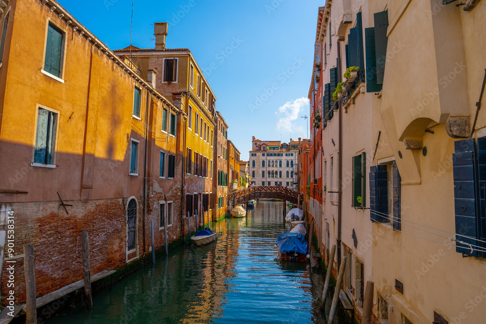Venice, Italy - June 05, 2024: Peaceful Venice Canal with Docked Boats. Venice, Italy - June 05, 2024: Peaceful Venice Canal with Docked Boats.