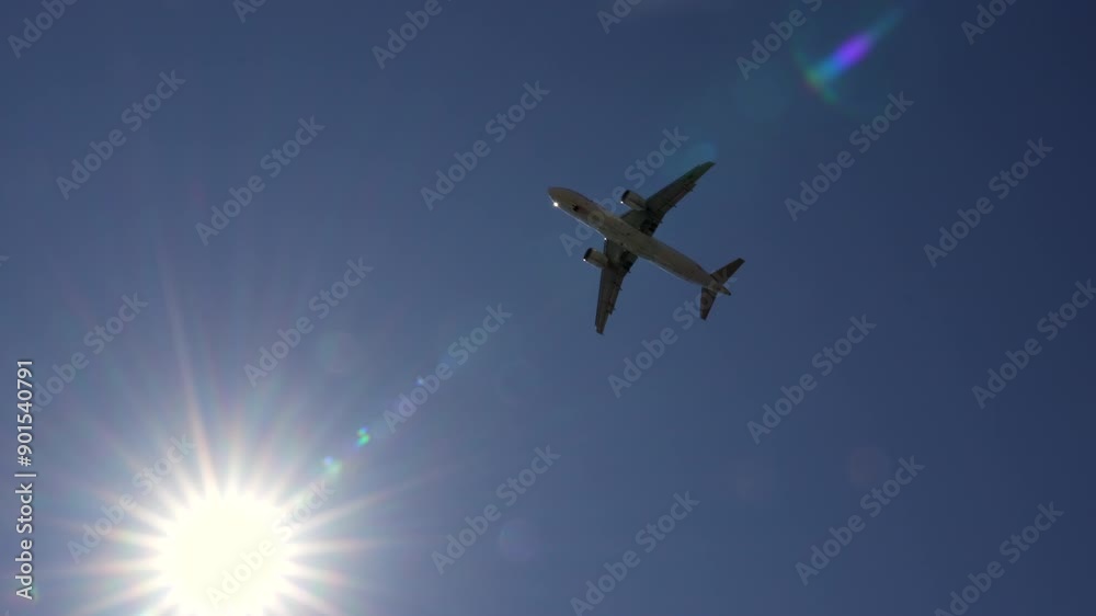 Airplane flying overhead passing the sun