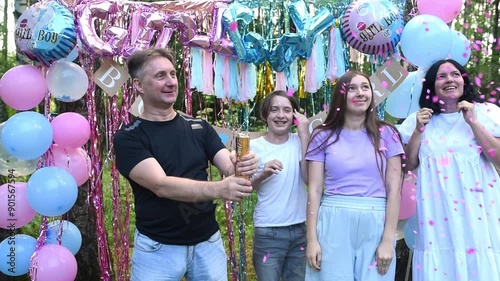 Wallpaper Mural A family with two children at a Gender Reveal Party finds out that the youngest child is a girl. The father blows up a popper. Pink confetti flies out, the mother, son and daughter look at the color o Torontodigital.ca