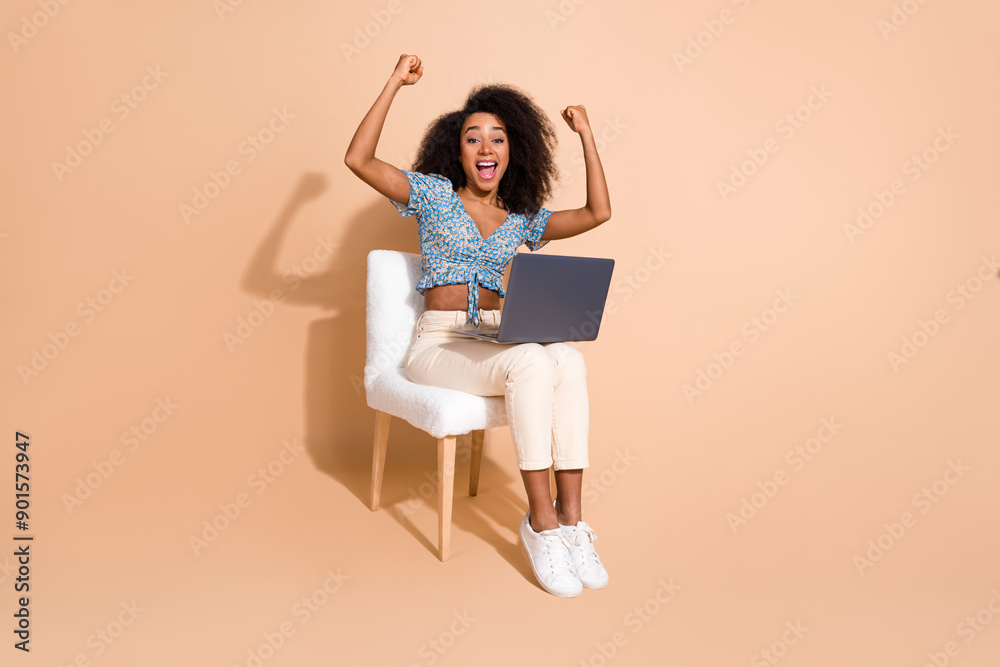 Full length photo of lucky attractive lady dressed blue blouse winning game modern gadget empty space isolated beige color background