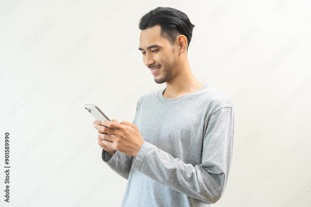 Happy asian young man, male using mobile smart phone, read good news online, laugh excited getting offer, great positive surprise, celebrate success on smartphone. Smile guy isolated on background. Happy asian young man, male using mobile smart phone, read good news online, laugh excited getting offer, great positive surprise, celebrate success on smartphone. Smile guy isolated on background.