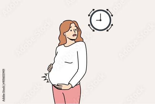 Pregnant woman measures contractions and looks at watch, waiting for ambulance to arrive from maternity hospital. Girl tracks intervals between contractions while waiting for labor to begin.