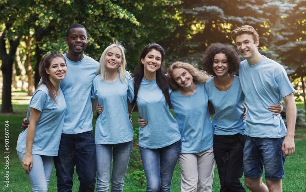 Group of happy young diverse volunteers embracing at park, ready for work, copy space Group of happy young diverse volunteers embracing at park, ready for work, copy space