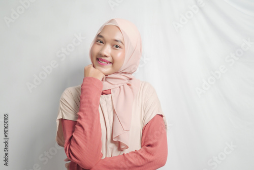 Smiling Young Woman Wearing a Pink Hijab and Coral Sweater photo