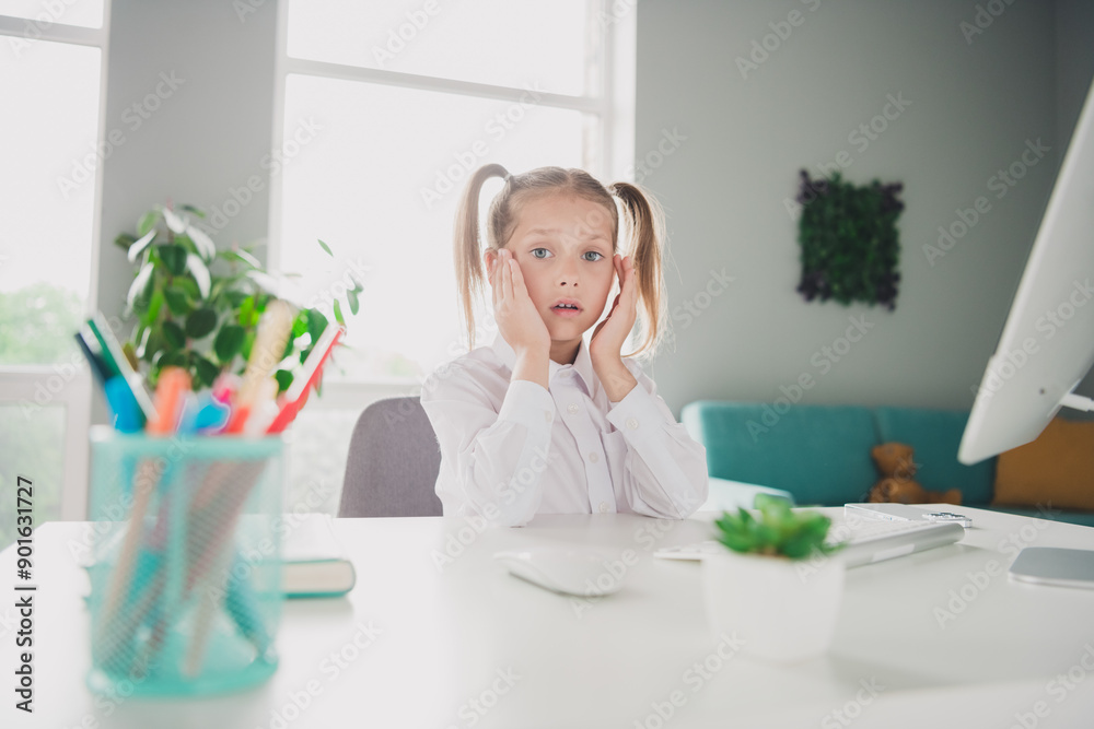Photo of cute small schoolgirl stressed frightened reaction computer online lesson home education concept school interior Photo of cute small schoolgirl stressed frightened reaction computer online lesson home education concept school interior