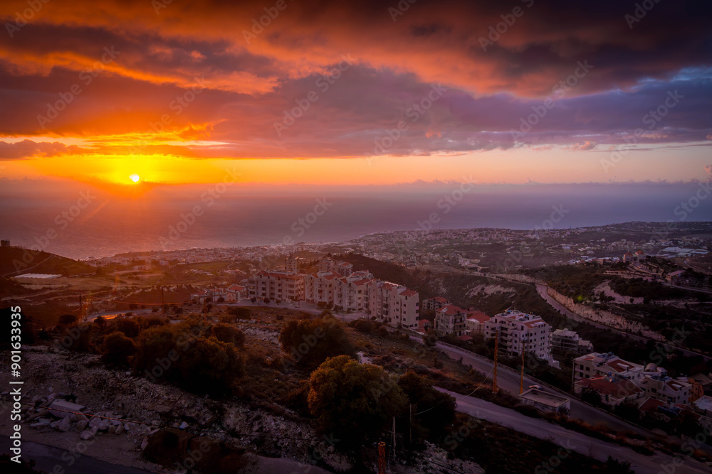 Obraz premium The scenic sunset over Mediterranean sea in Beirut, Lebanon capital, in the Lebanese mountains during the cloudy day. 