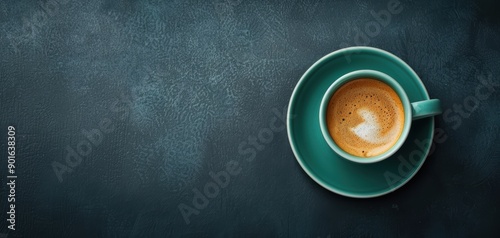 A stylish teal cup holding a rich espresso shot on a dark textured background, perfect for coffee lovers and culinary enthusiasts. photo