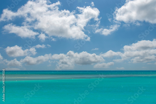 Colorful seascape and skyscape background with white clouded blue sky and turquoise colored shallow water off the coast of Key West, FL, USA