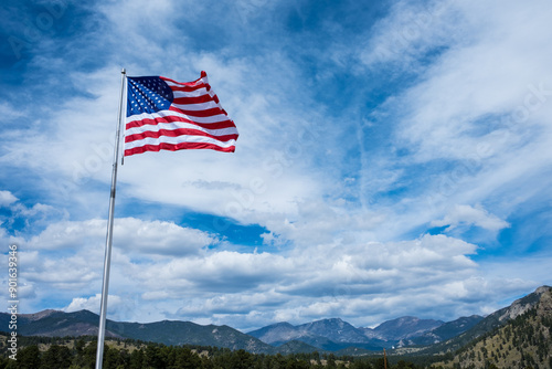 American Flag Flying over Moutain Range on a Sunny Day