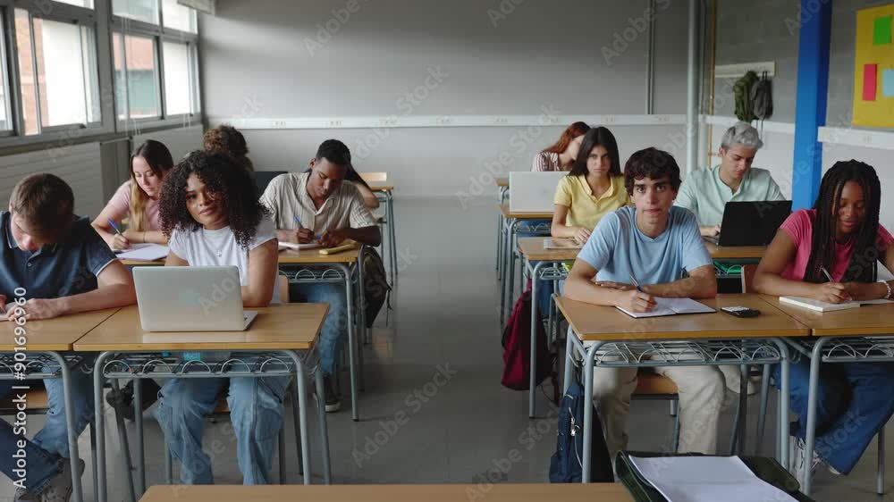 Young group of diverse students studying at high school classroom. Education and back to school concept. Young group of diverse students studying at high school classroom. Education and back to school concept.