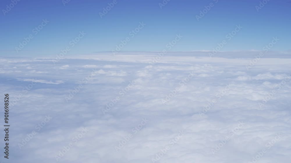 Wing of an airplane jet flying above clouds with blue sky from the window in traveling and transportation concept. Nature landscape background. Wing of an airplane jet flying above clouds with blue sky from the window in traveling and transportation concept. Nature landscape background.