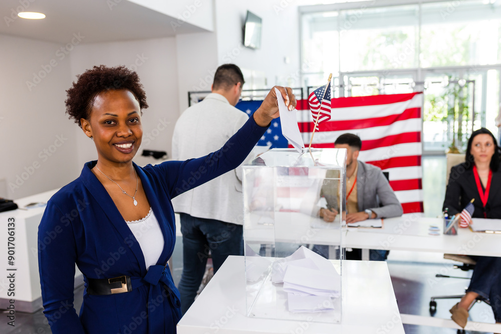 Obraz premium African American voter placing ballot in ballot box polling place in America
