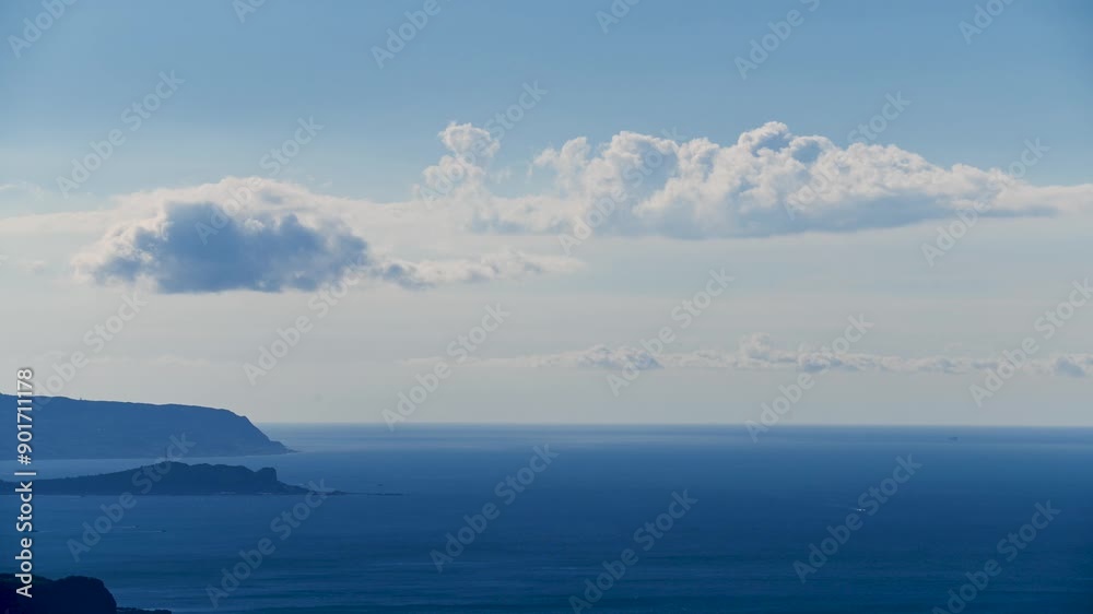 Against the background of the blue sky, white clouds dance on the calm sea, creating a tranquil scene. Capture the atmosphere of a summer afternoon. Xindian District, Taiwan. Against the background of the blue sky, white clouds dance on the calm sea, creating a tranquil scene. Capture the atmosphere of a summer afternoon. Xindian District, Taiwan.