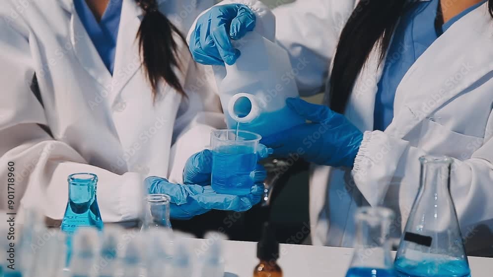 chemist,scientist hand dropping chemical liquid into test tube, science research and development concept chemist,scientist hand dropping chemical liquid into test tube, science research and development concept
