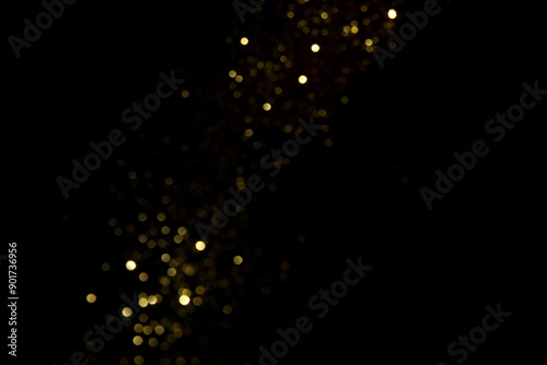 Golden blurred bokeh lights on black background. Glitter sparkle stars for celebrate. Overlay for your design