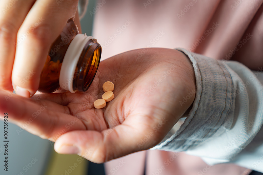 woman taking tablet of vitamin or supplement woman taking tablet of vitamin or supplement