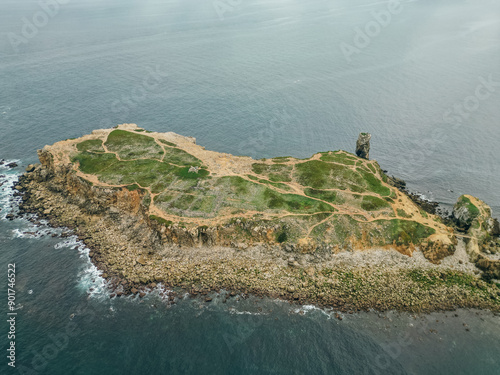 Rock formations of the Papoa island in the site of geological interest of the cliffs of the Peniche peninsula, portugal photo