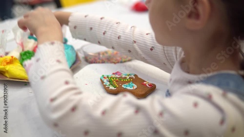 A Child Having Fun Decorating a Cookie with Colorful Icing to Create a Beautiful Dessert