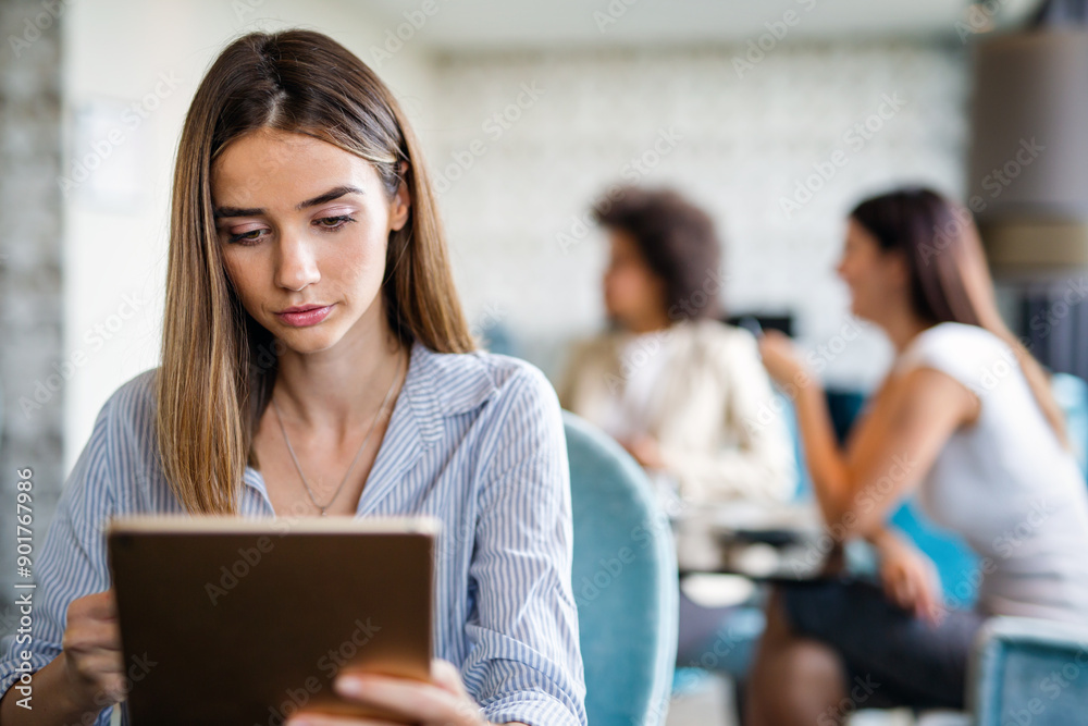 Young happy successful business woman working with tablet in corporate office Young happy successful business woman working with tablet in corporate office
