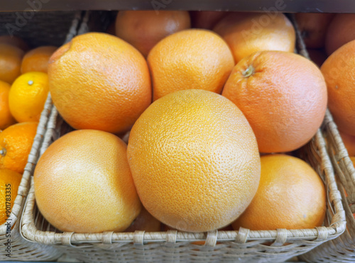 buying fruits(lemon, orange, tangerine, citrus, grapefruite)  at the market photo