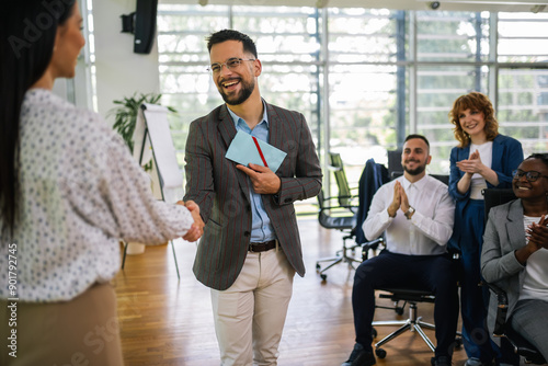Canvas Print Happy young man employee excited by unexpected money bonus in envelope from boss