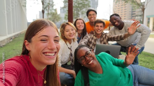 Group of international friends having fun, gesturing and looking at camera together. Student people smiling on a friendly meeting outside. Young teenagers bonding and celebrating on a social gethering