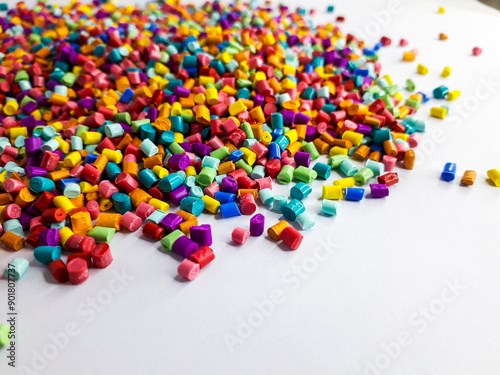 Various colors of masterbatch granules mixed on a white background.Color pigment carrier polymers in the plastics industry photo